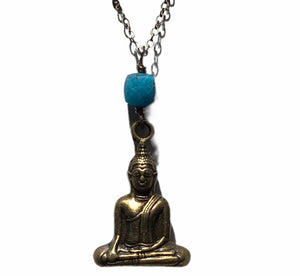 Sitting buddha charm necklace on long chain.